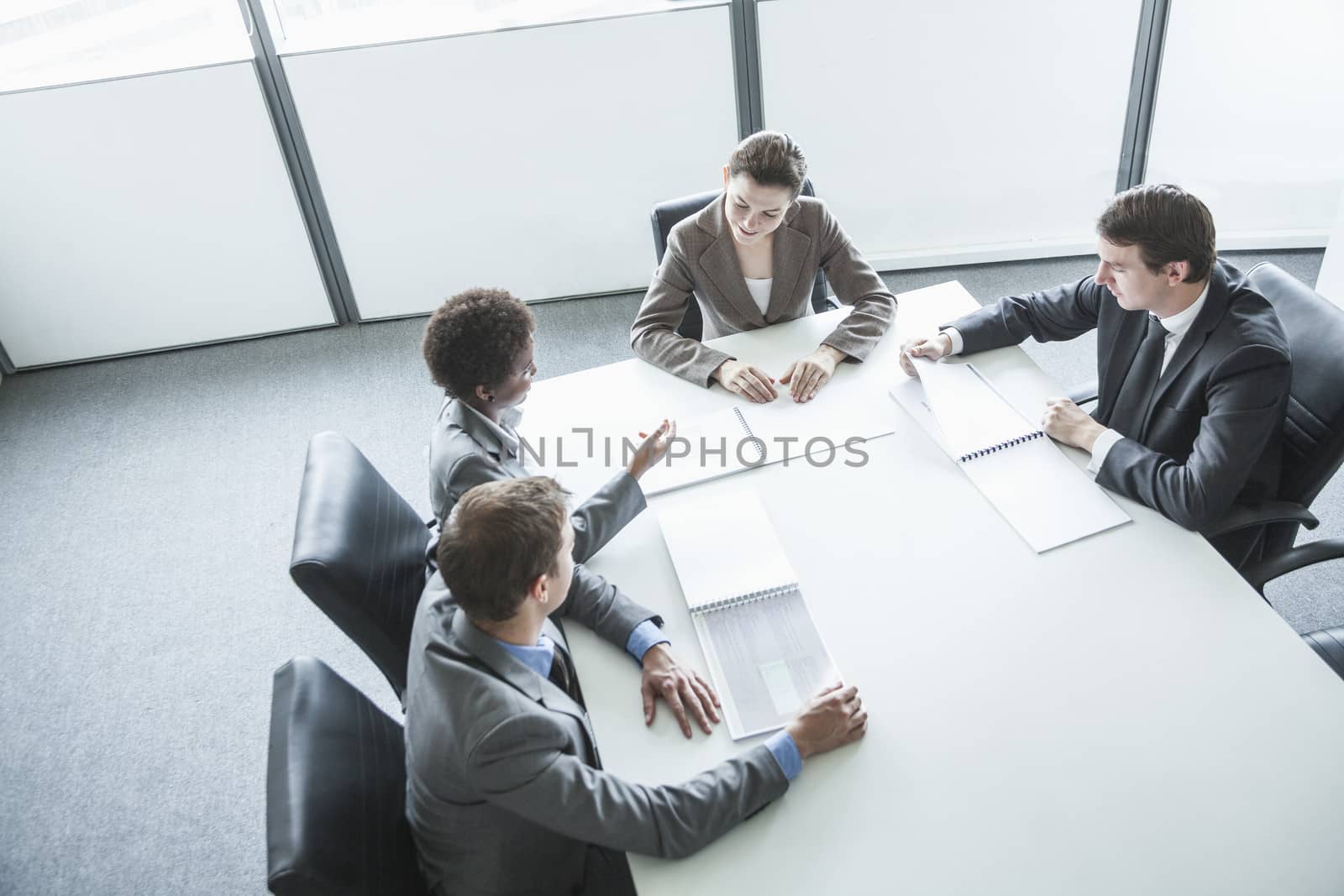 Four business people sitting around a table and having a business meeting, high angle view 