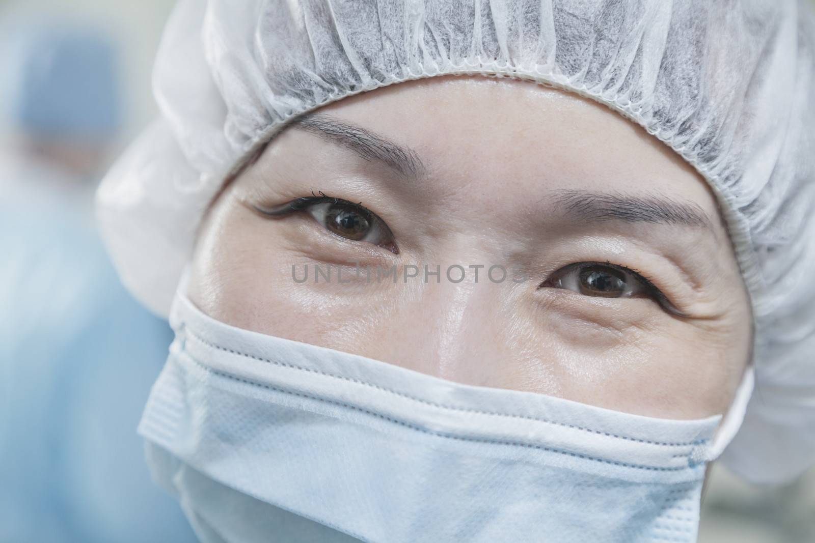 Portrait of surgeon with surgical mask and surgical cap in the operating room 