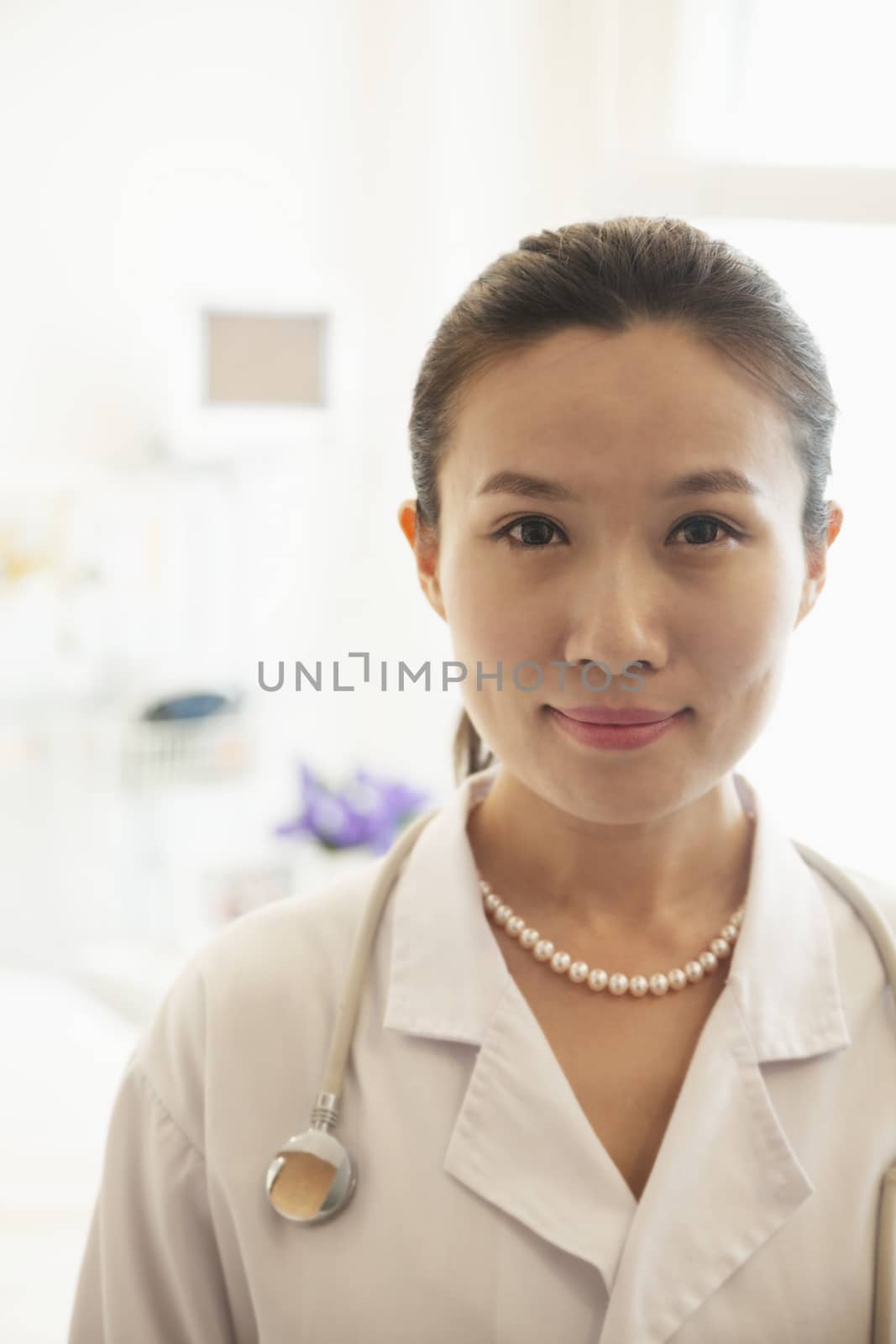 Portrait of smiling young female doctor in a hospital 