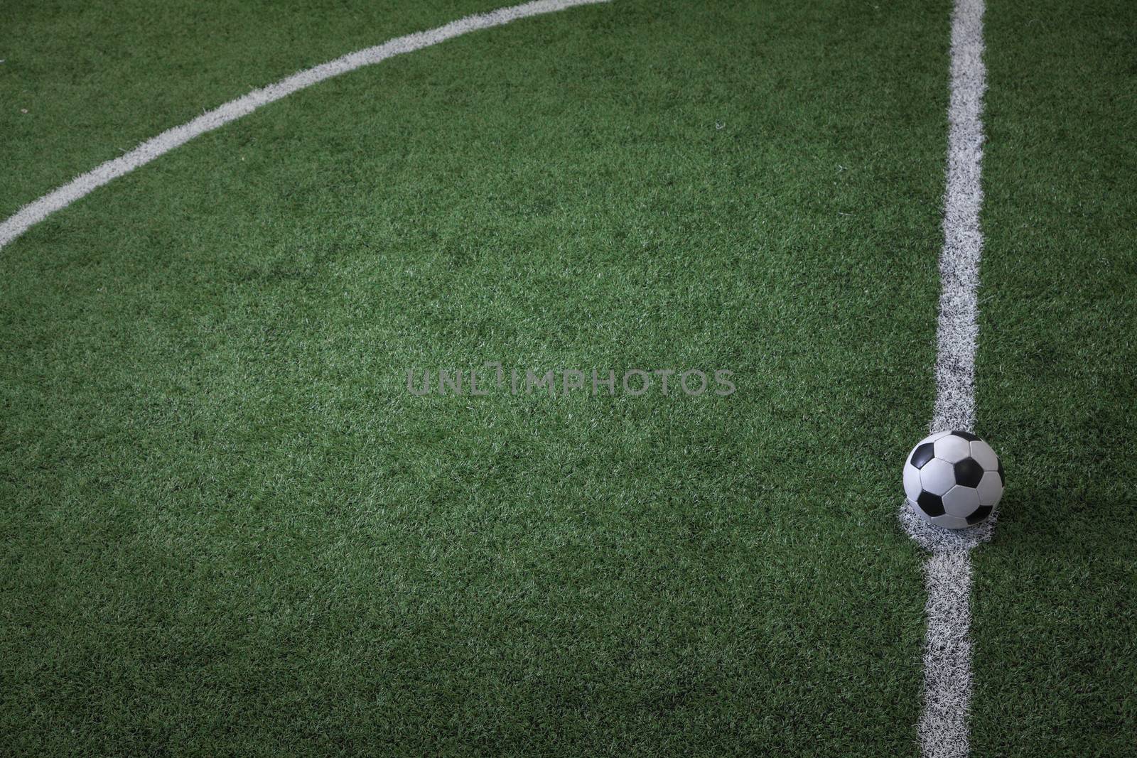 Soccer field with soccer ball on the line, high angle view