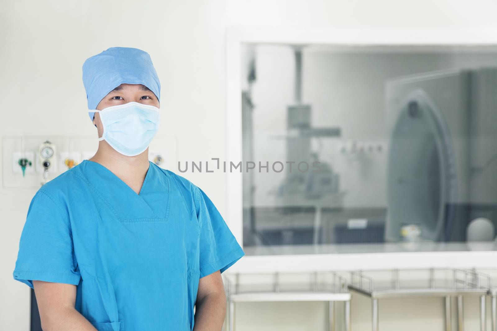 Portrait of young surgeon wearing surgical mask in the operating room