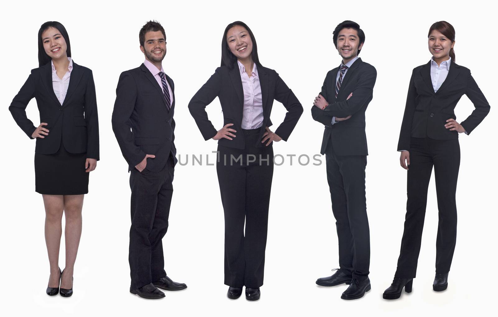 Portrait of five young smiling businesswomen and young businessmen, looking at camera, studio shot by XiXinXing