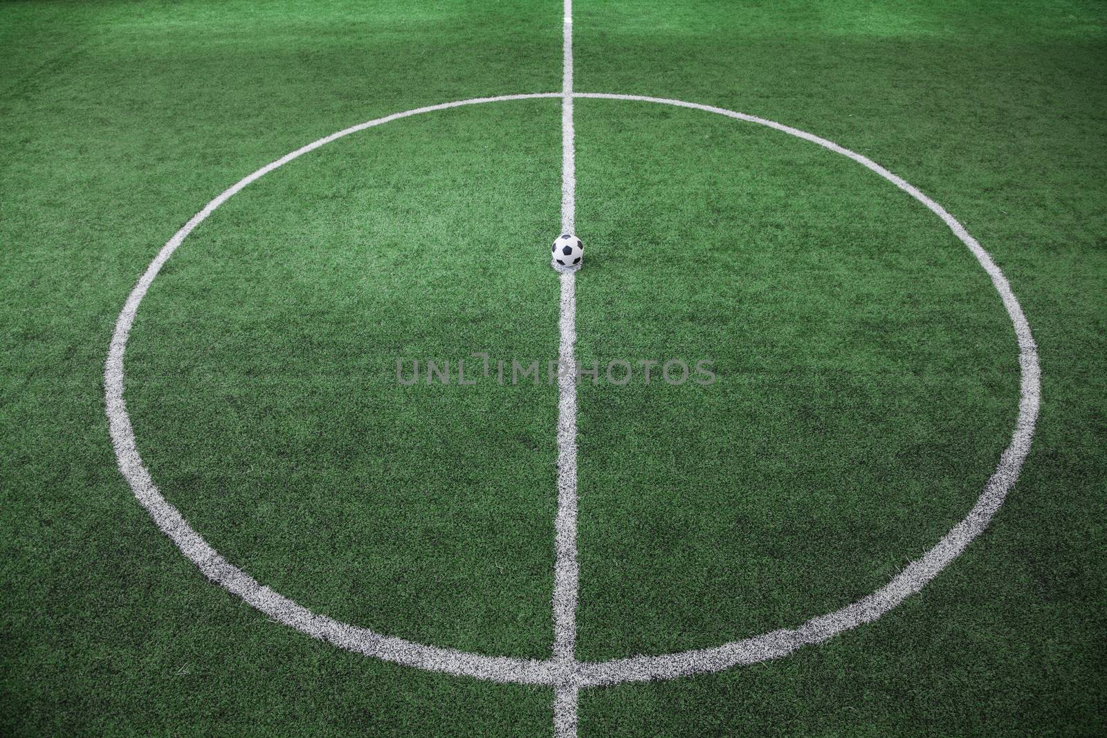Soccer field with soccer ball on the line, high angle view by XiXinXing
