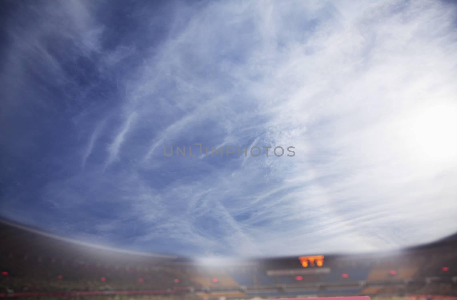 Digital composit of soccer field and blue sky