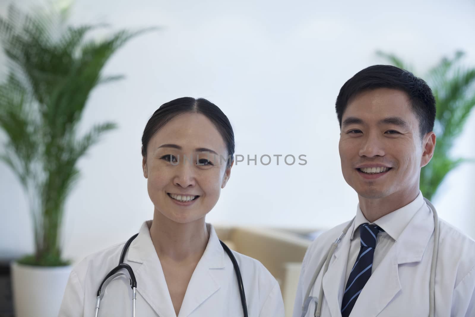 Portrait of two smiling doctors in the hospital