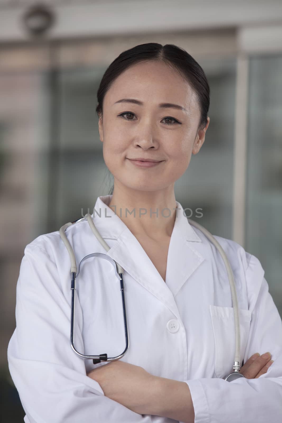 Portrait of female doctor with arms crossed outside of the hospital