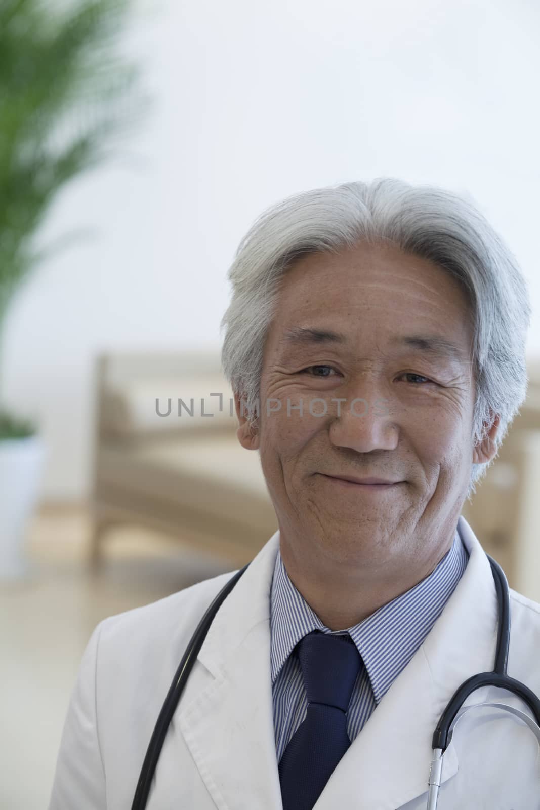 Portrait of mature doctor looking at camera and smiling