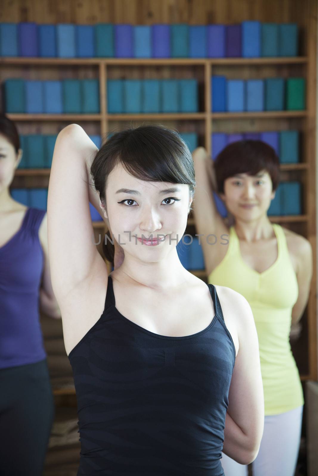 Three young women stretching and doing yoga, looking at camera,  by XiXinXing
