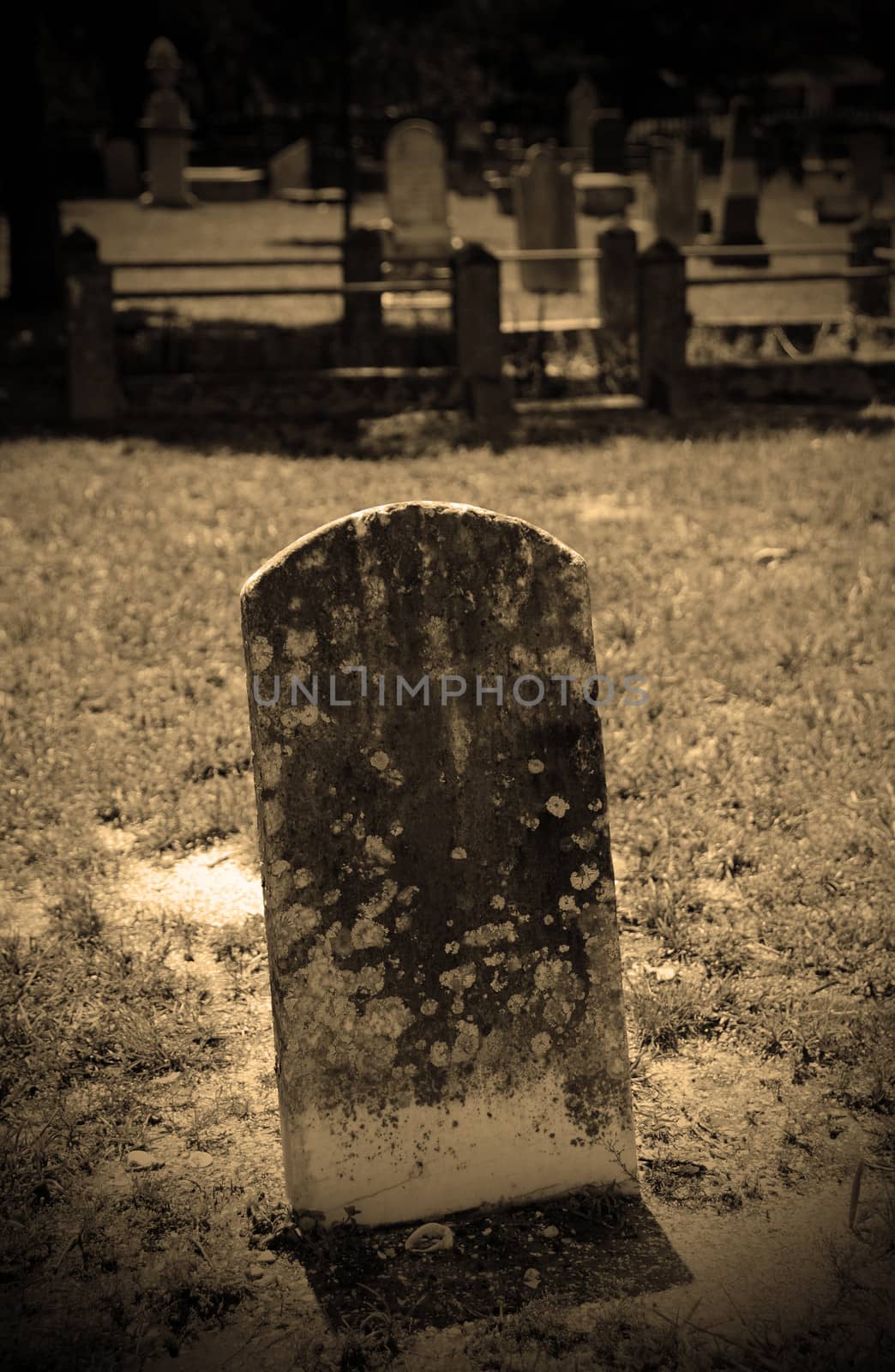old grave and headstone in graveyard