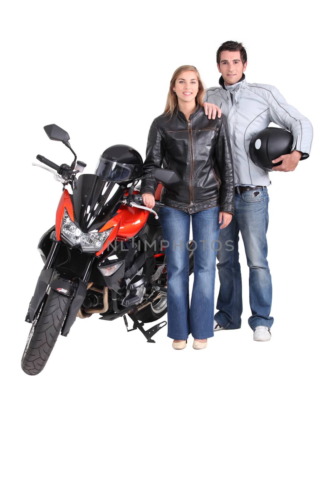 Biking couple with a red motorcycle by phovoir