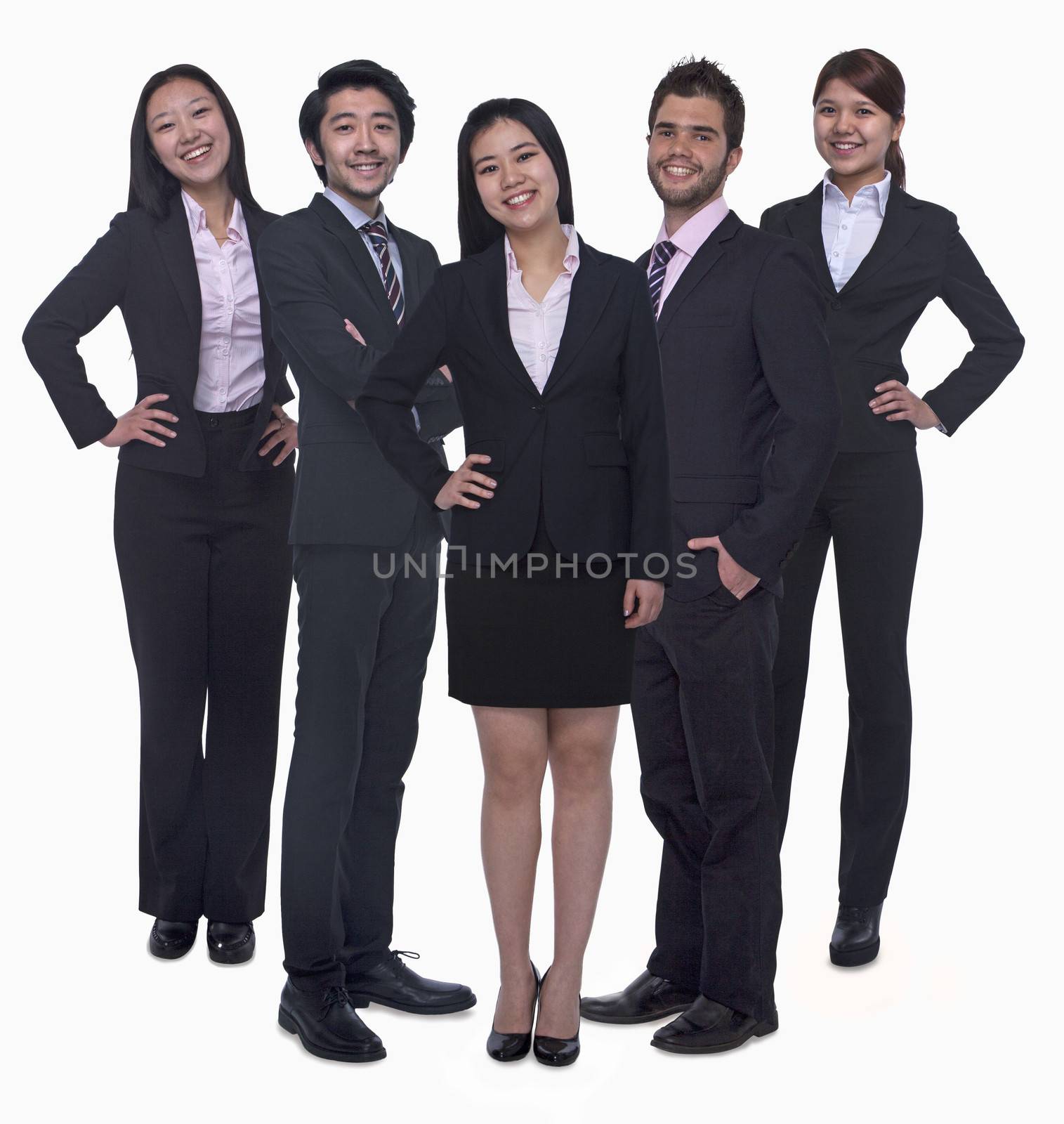 Portrait of five young smiling businesswomen and young businessmen, looking at camera, studio shot by XiXinXing