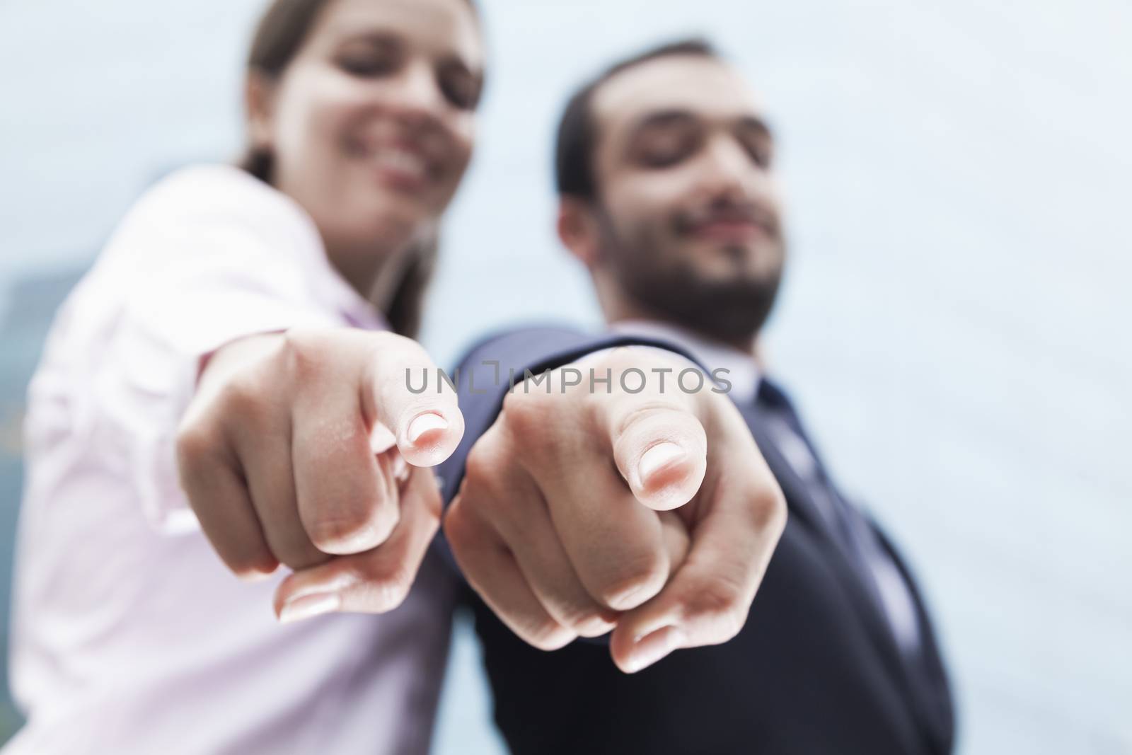 Close-up of two business people's fingers pointing at camera