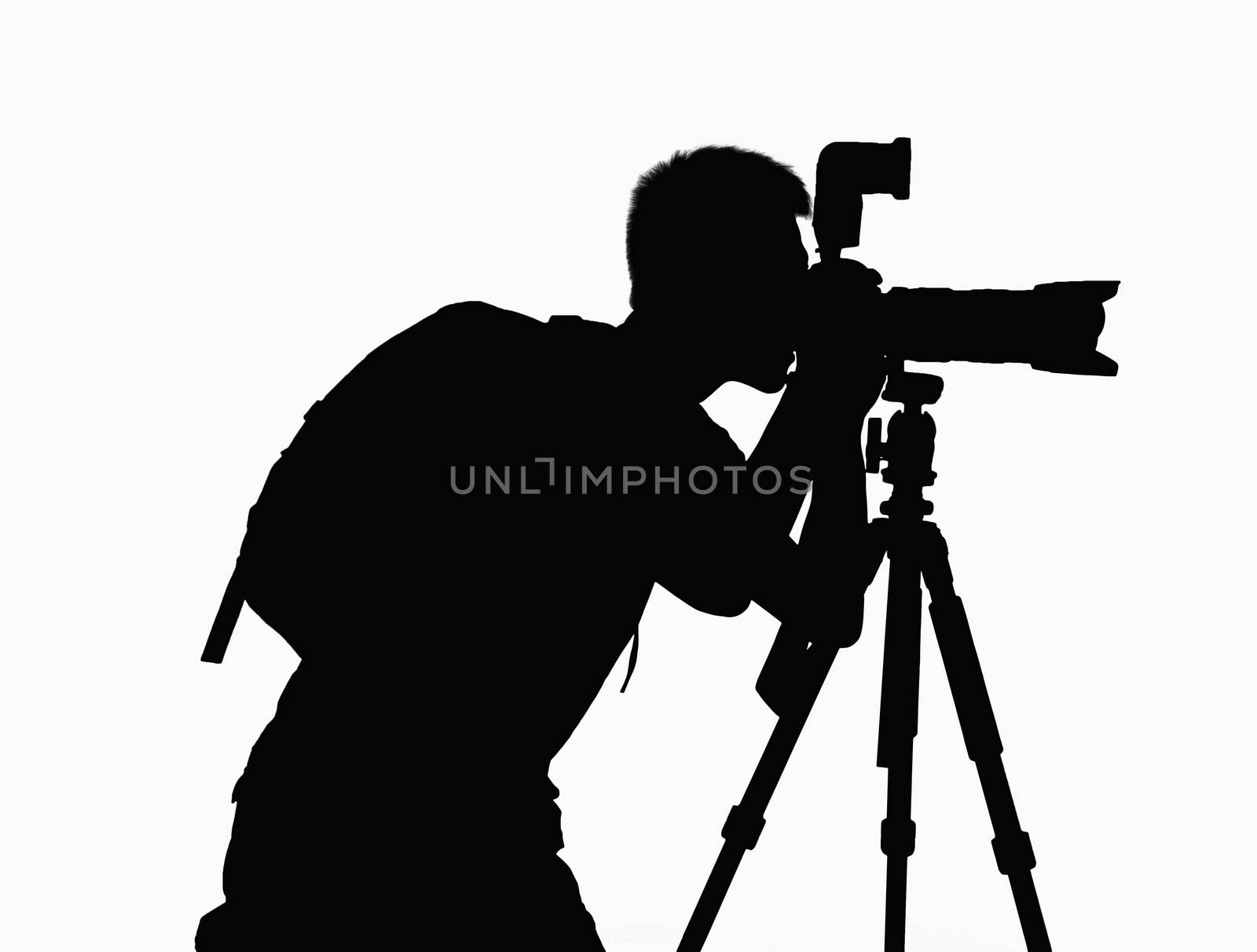 Silhouette of man taking pictures with camera on tripod.