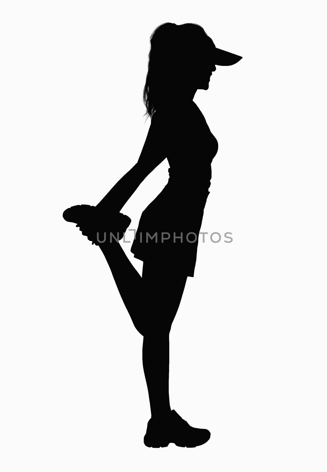 Silhouette of woman stretching leg.  by XiXinXing