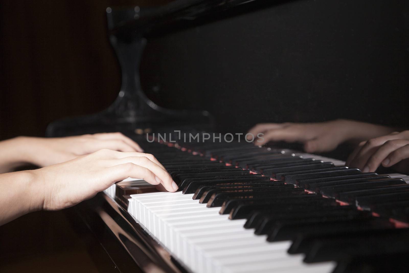 Close-up of hands playing the piano