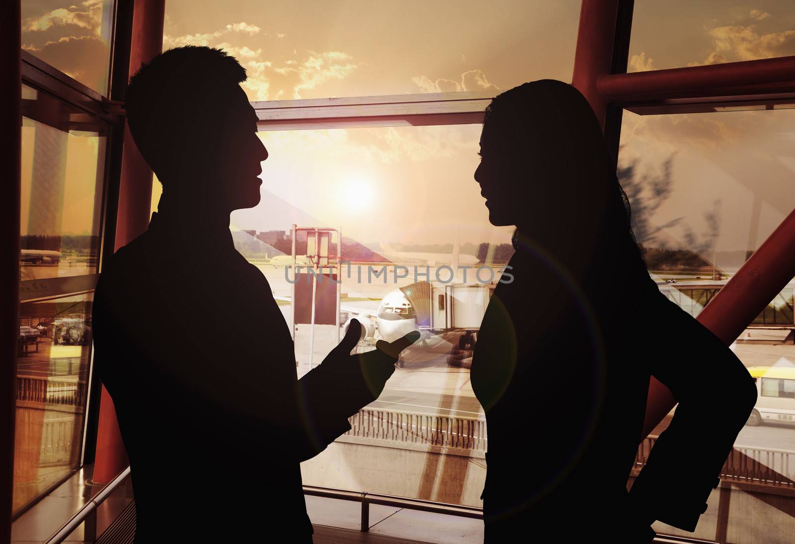 Two business people talking in the airport, Silhouette by XiXinXing