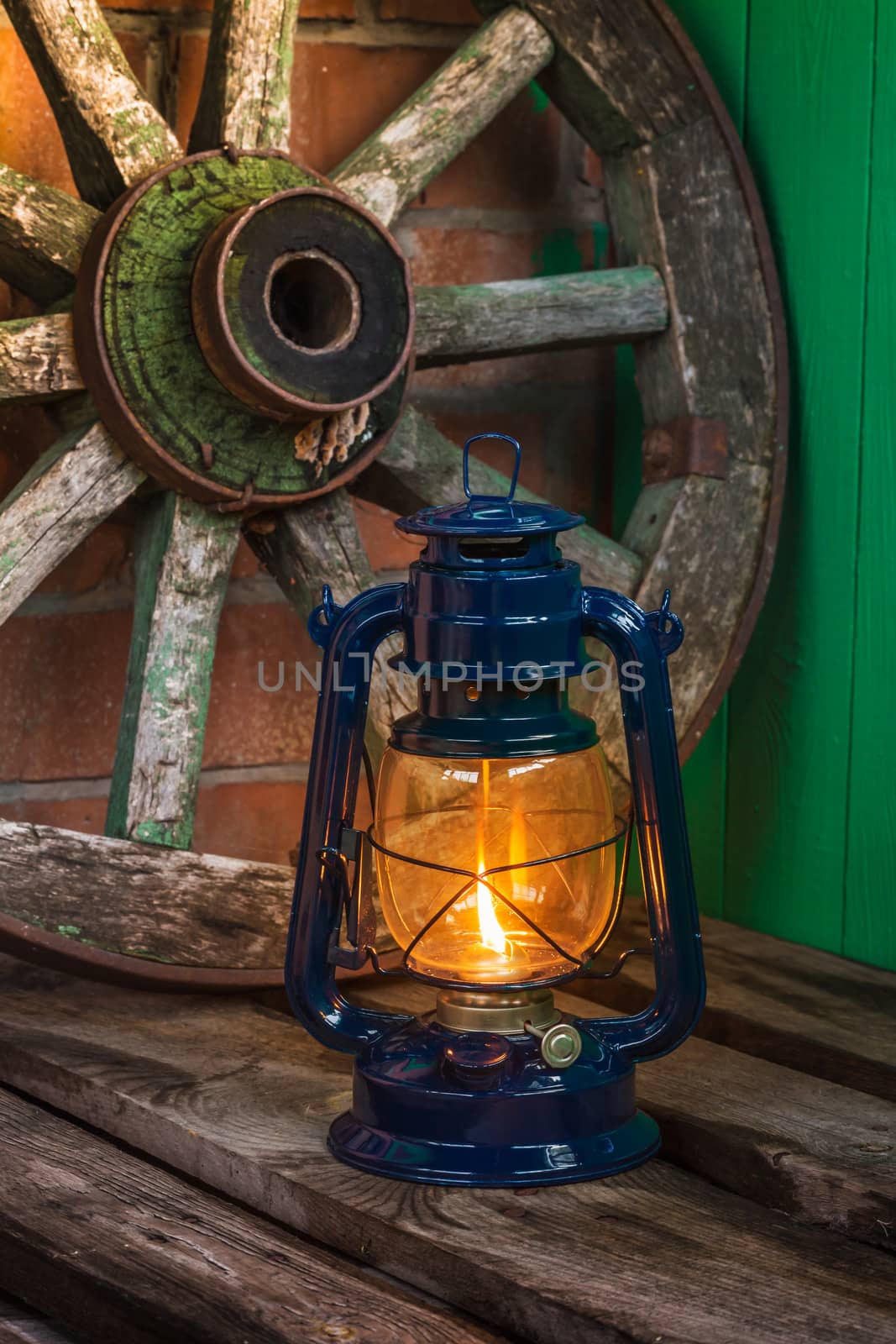 kerosene lamp  against the background wagon wheel by oleg_zhukov