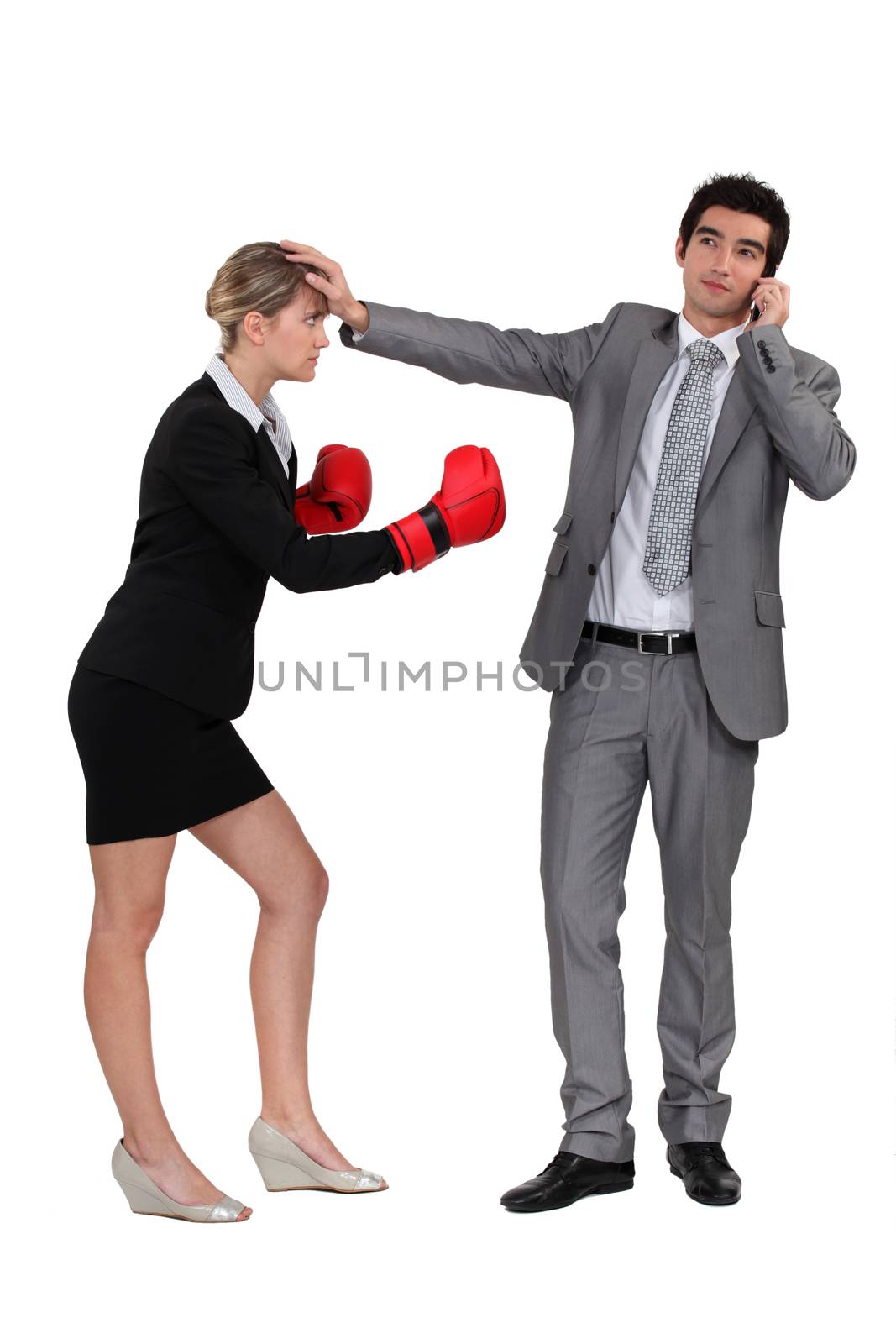 Businesswoman boxing on businessman on phone by phovoir