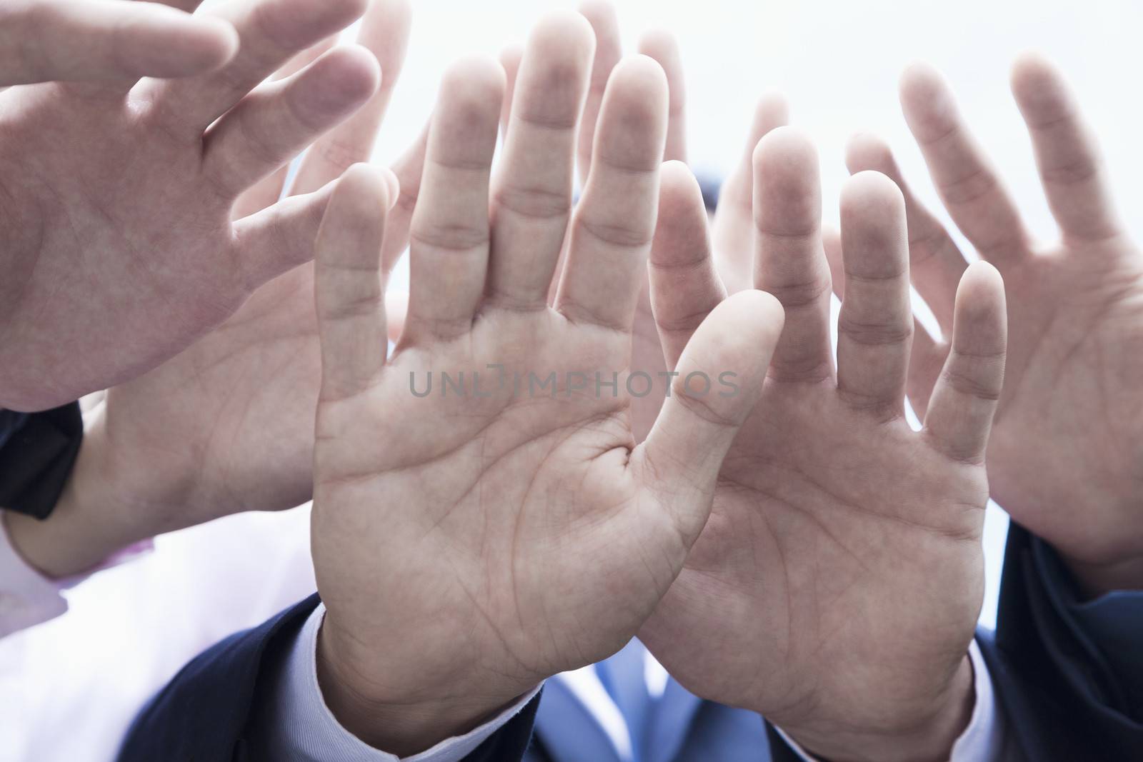 Close-up of four business people's hands by XiXinXing