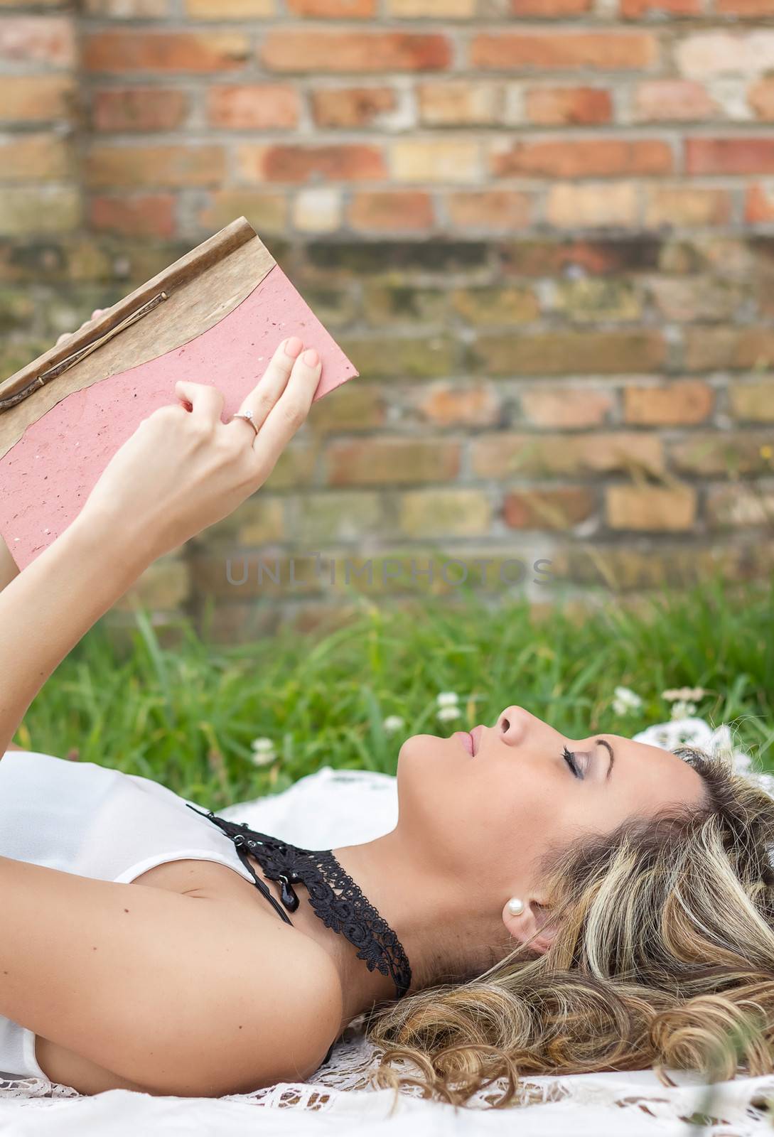 Beautiful girl with book on the grass by doble.d