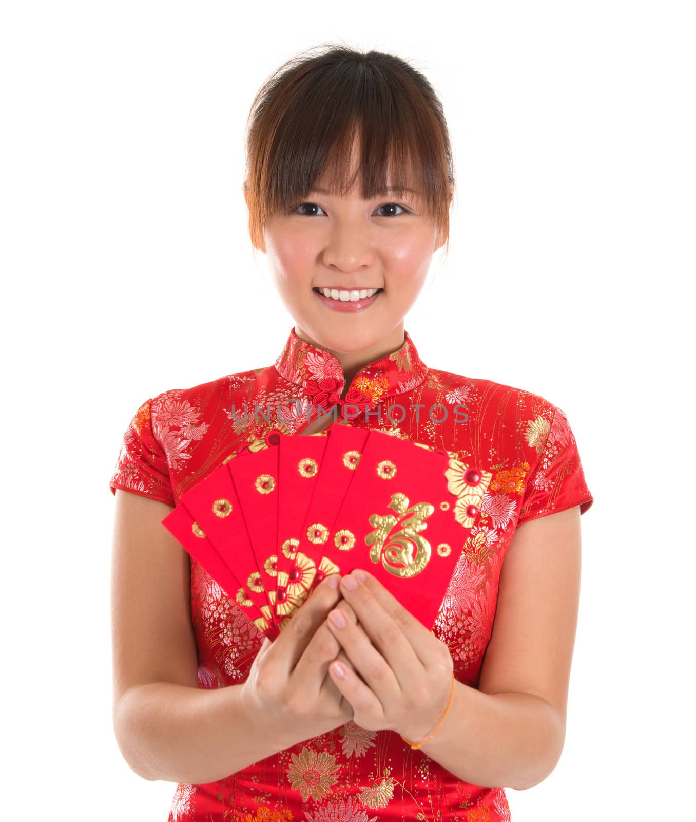 Pretty Asian woman with Chinese traditional dress cheongsam or qipao holding ang pow or red packet monetary gift. Chinese new year concept, female model isolated on white background.