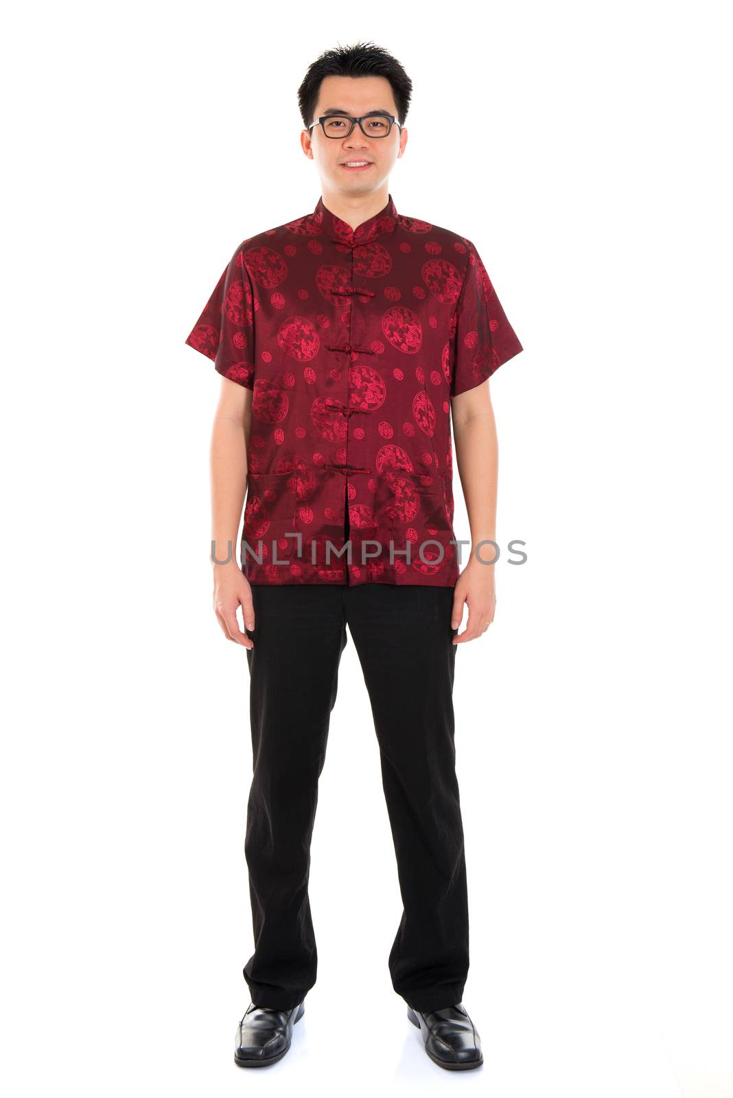 Full body portrait Asian man with Chinese traditional cheongsam or tang suit. Chinese New Year concept. Male model isolated on white background.