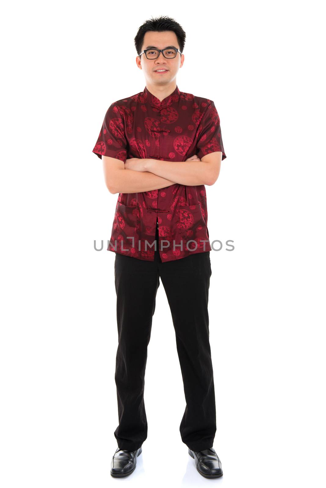 Full body portrait Asian male with Chinese traditional cheongsam or tang suit. Chinese New Year concept. Male model isolated on white background.