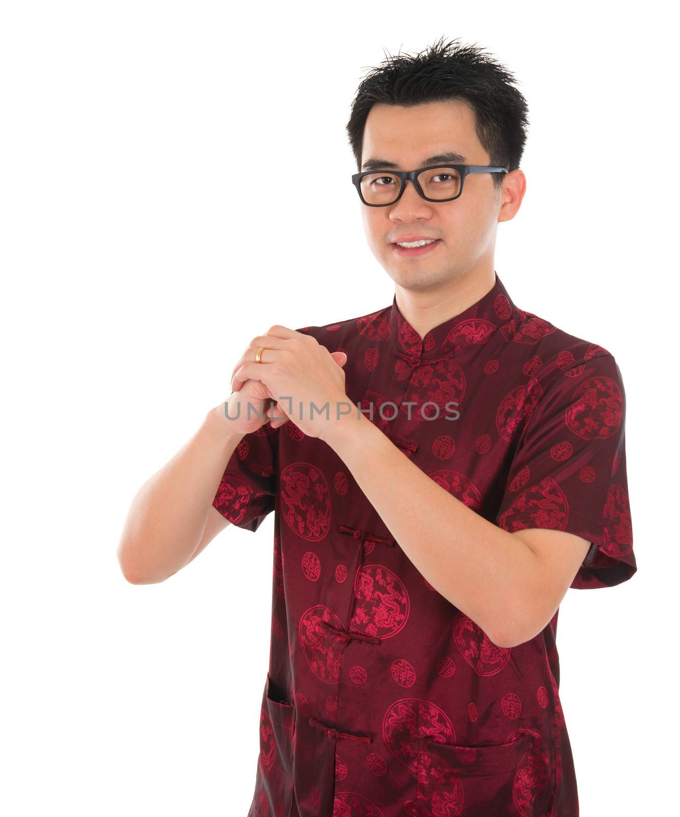 Asian male with Chinese traditional dress cheongsam or tang suit greeting. Chinese new year concept, male model isolated on white background.