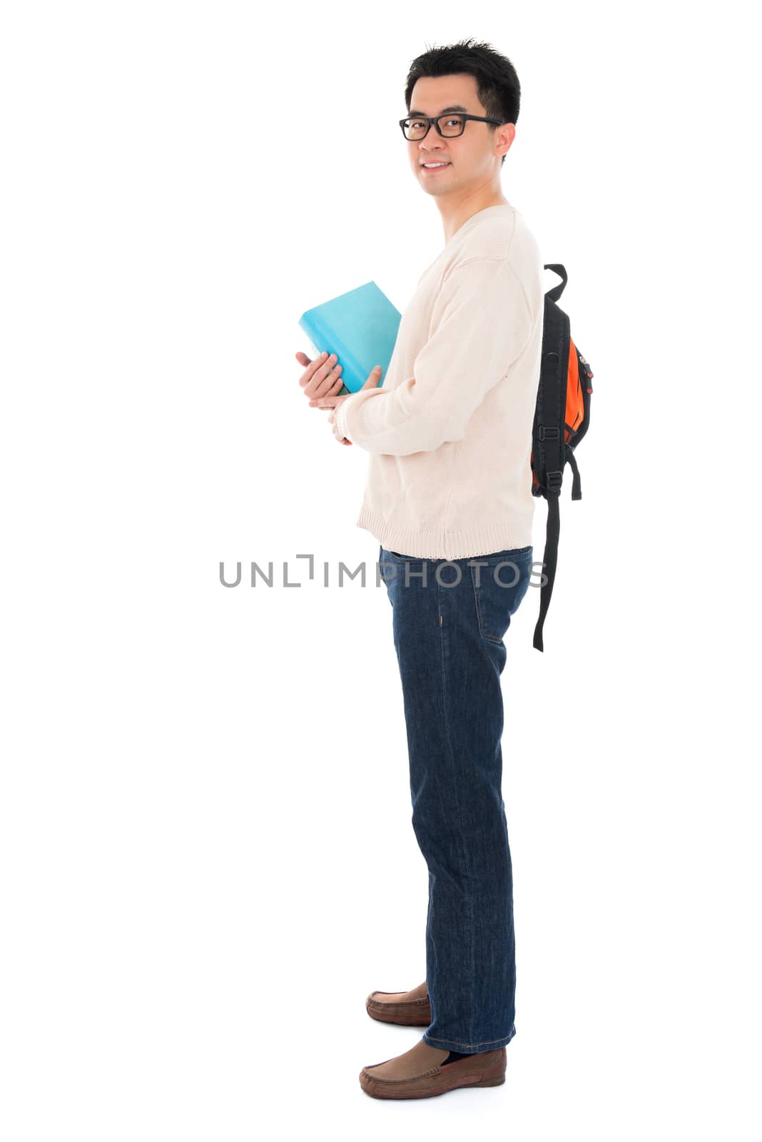 Full body Asian adult student in casual wear with school bag carrying text books standing isolated on white background. Asian male model.