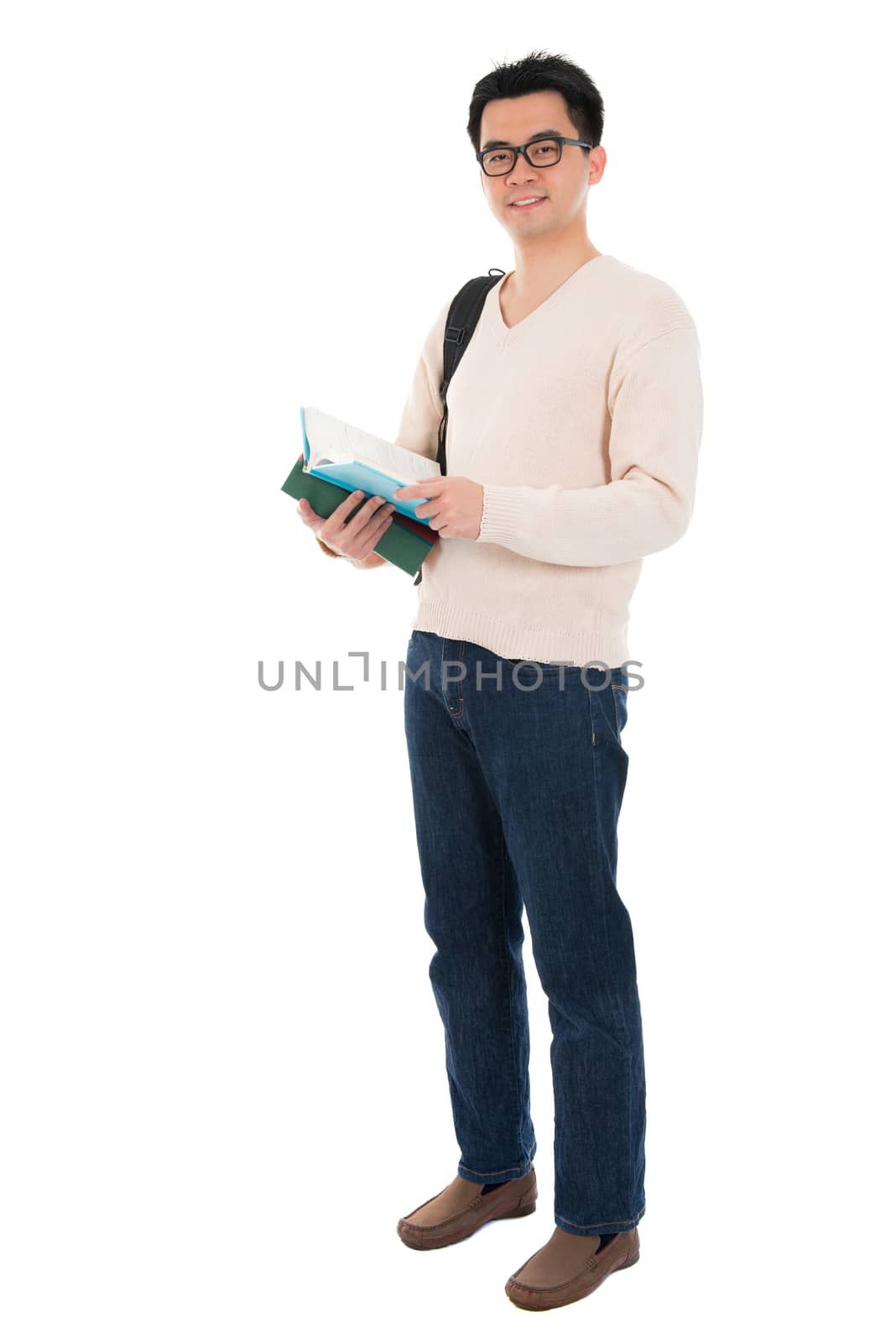 Full body Asian adult man student in casual wear with school bag carrying text books standing isolated on white background. Asian male model.