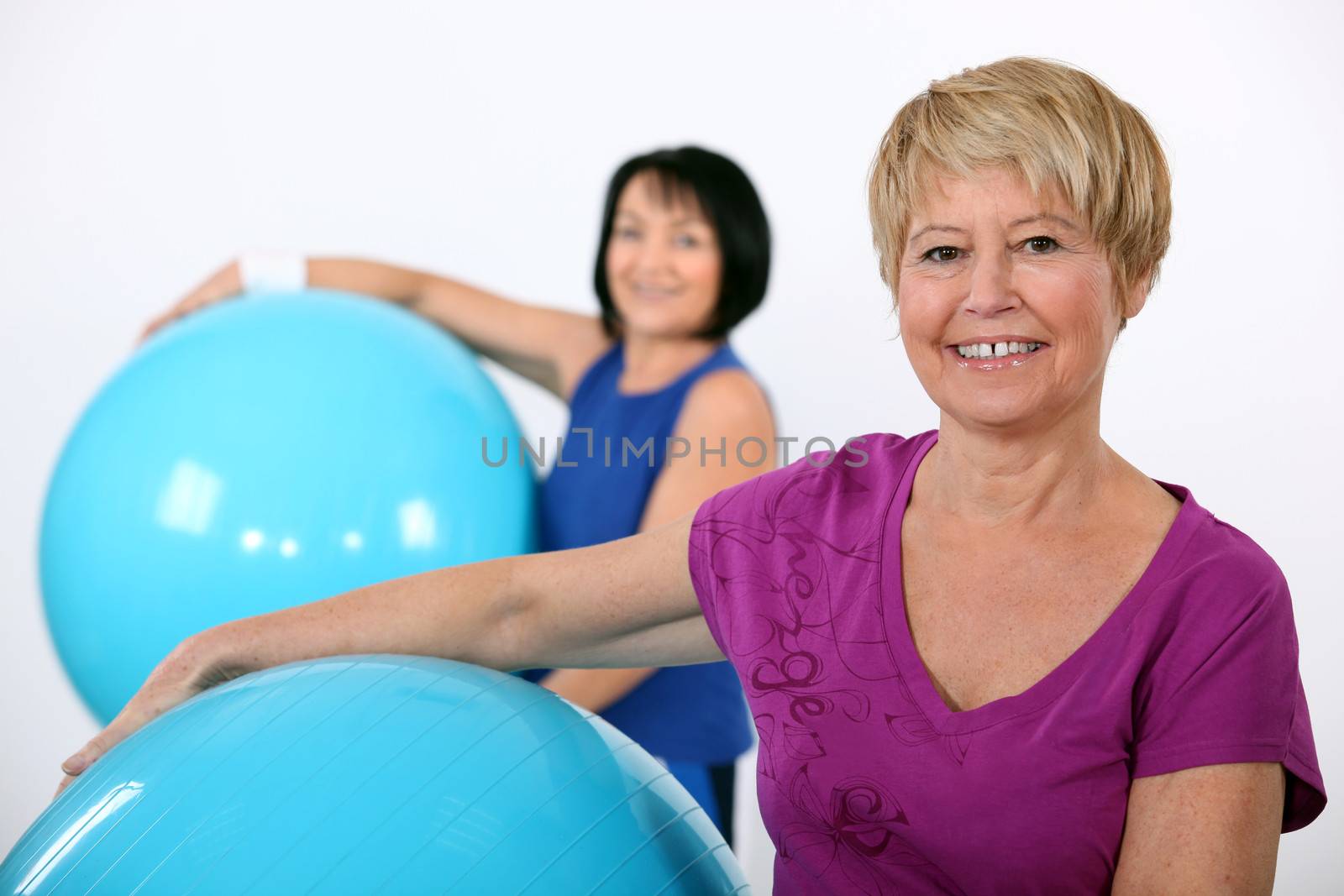 Older women in the gym by phovoir