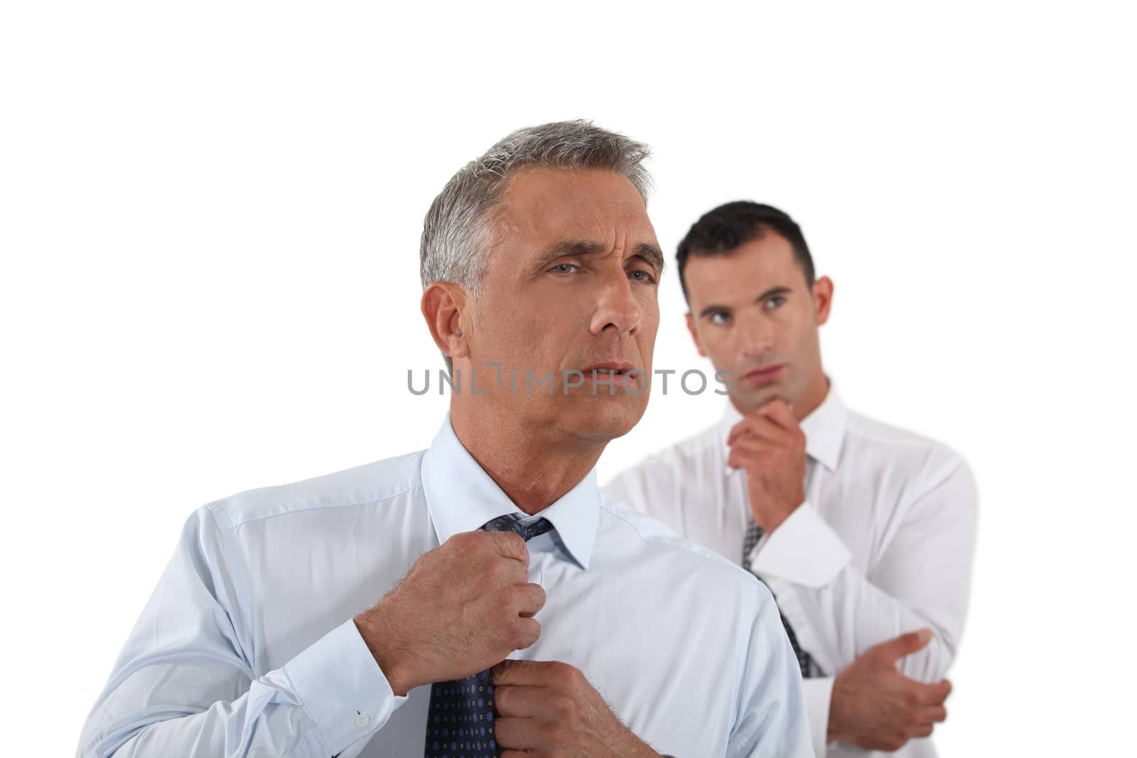 Senior businessman adjusting tie before meeting