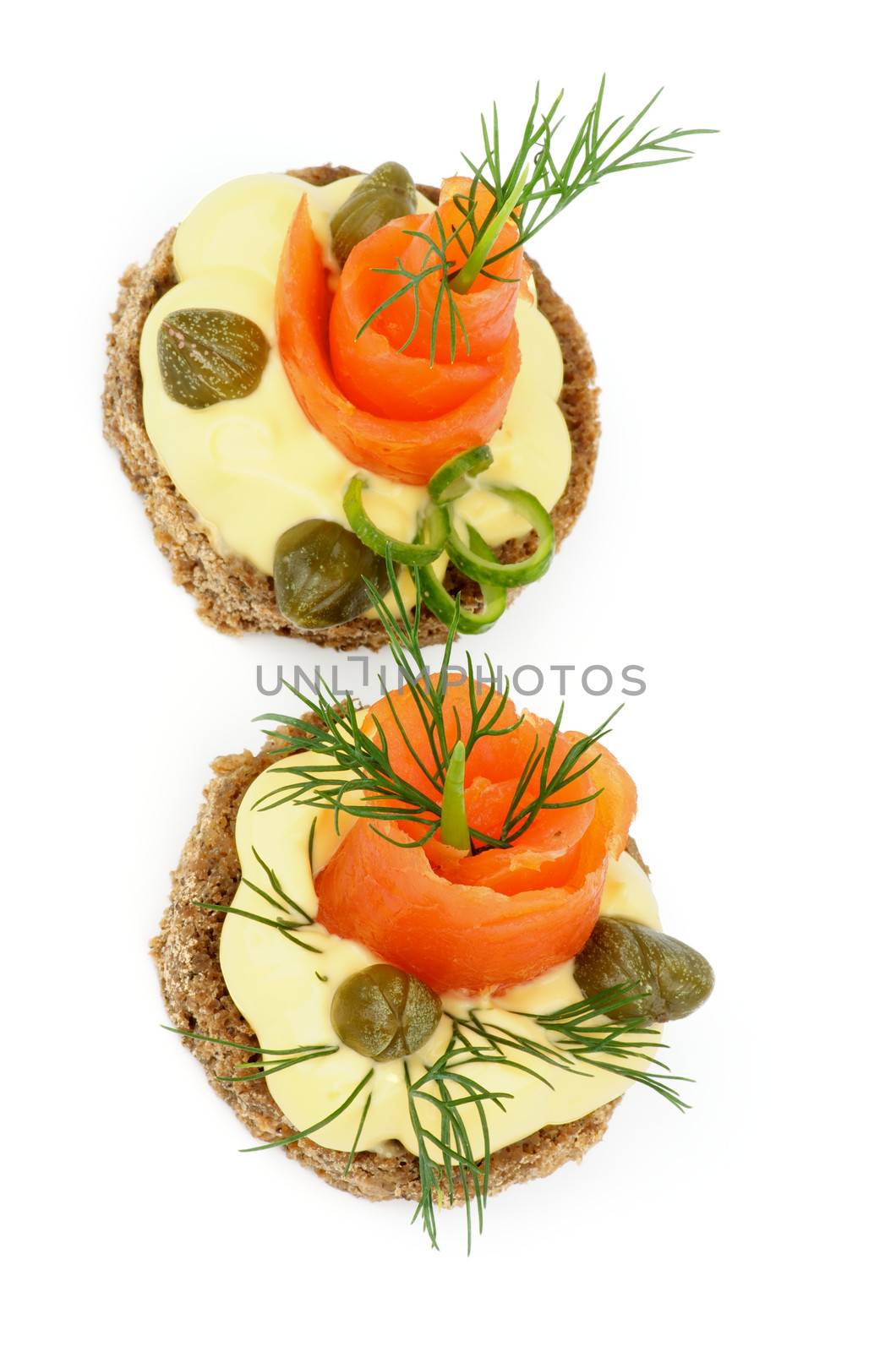 Two Delicious Snacks with Smoked Salmon, Greens, Cheese Cream and Capers isolated on white background. Top View