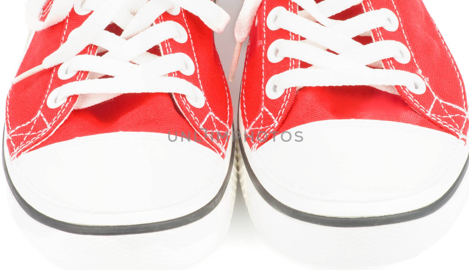 Noses of Trendy Red Gym Shoes closeup on white background