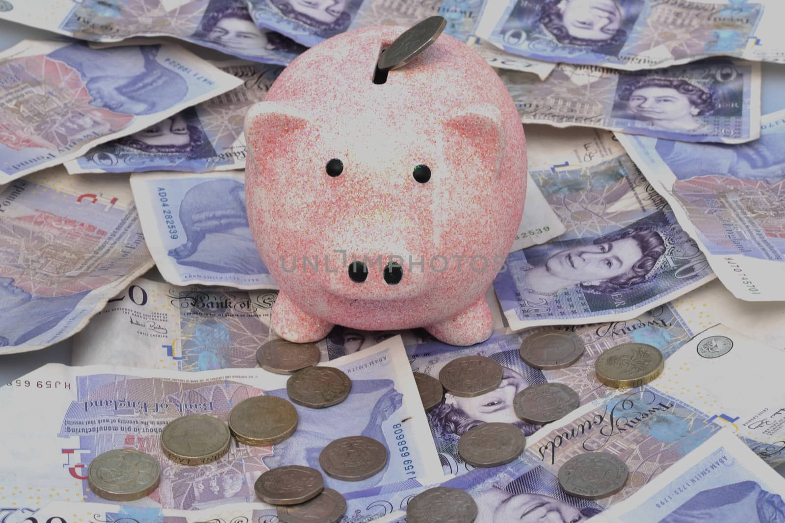 Piggy bank over notes coins by pauws99