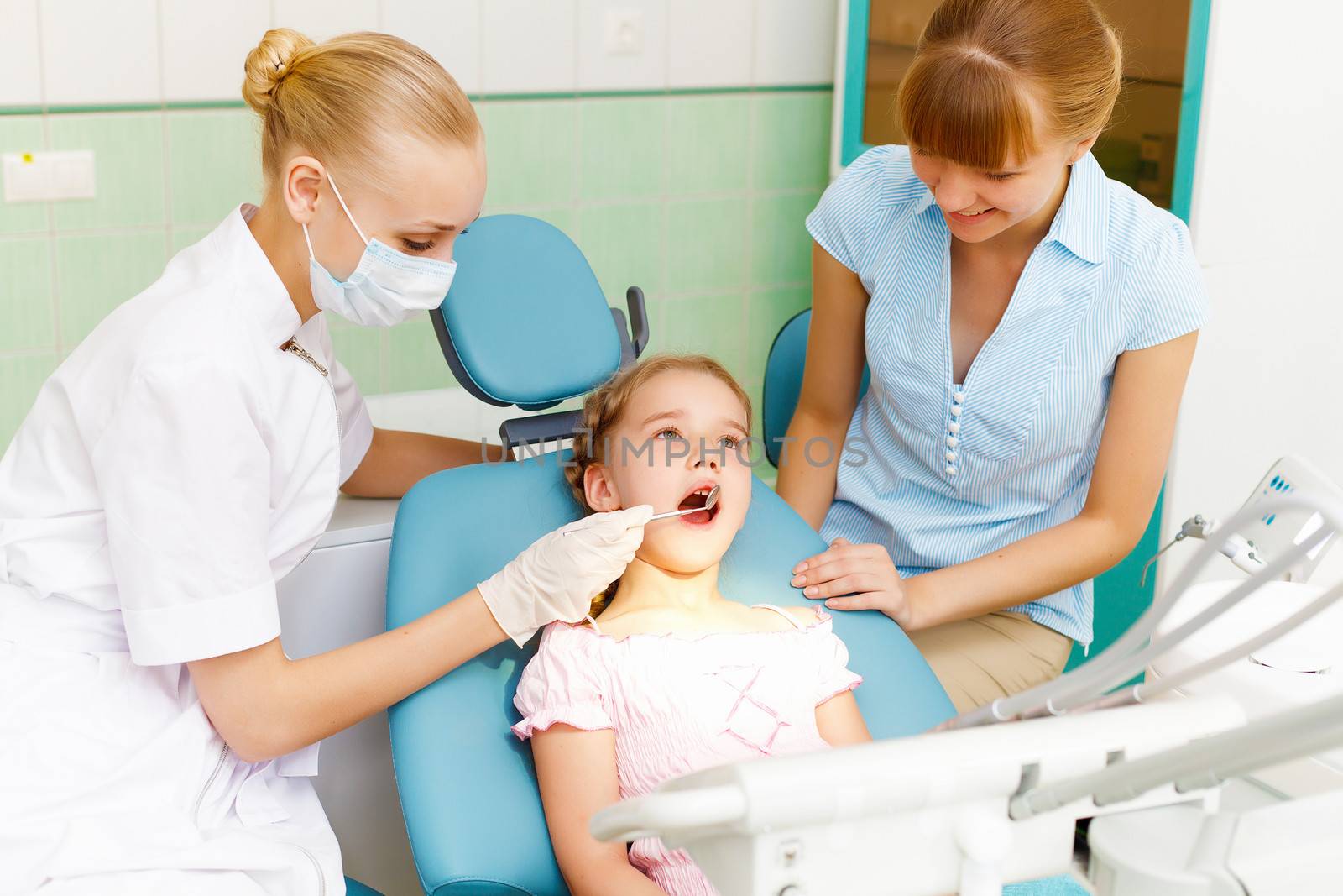 Little girl sitting in the dentists office