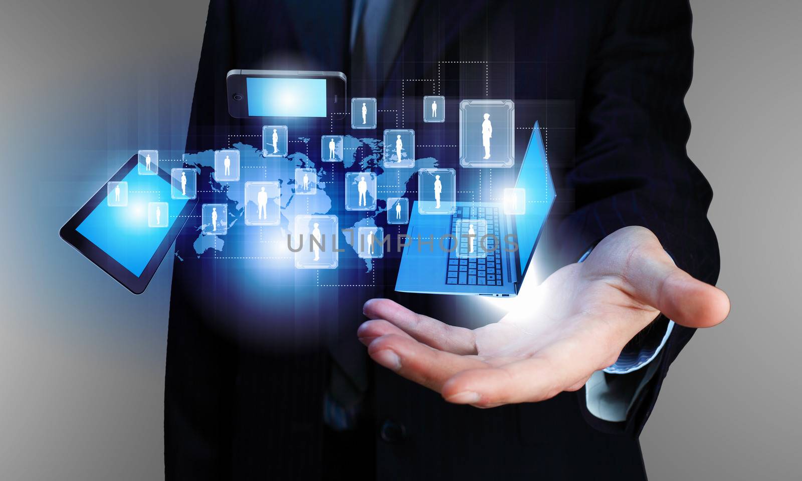 Image of business person holding devices in hands