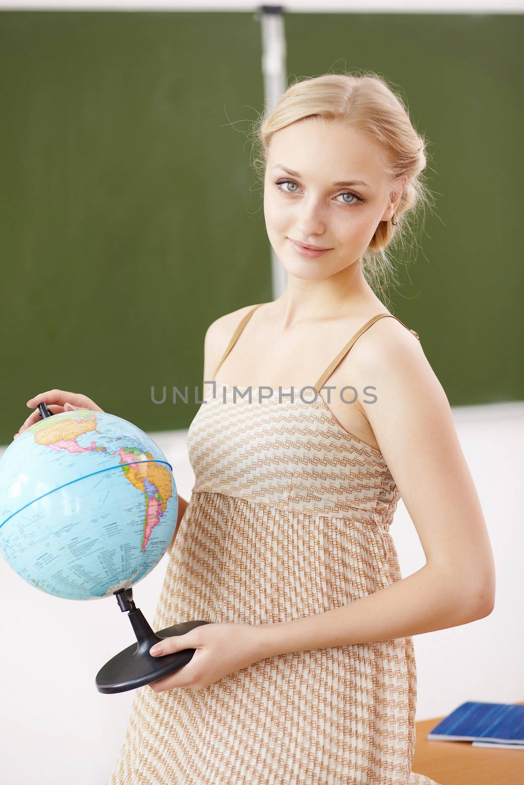 Teacher at school with a globe by sergey_nivens