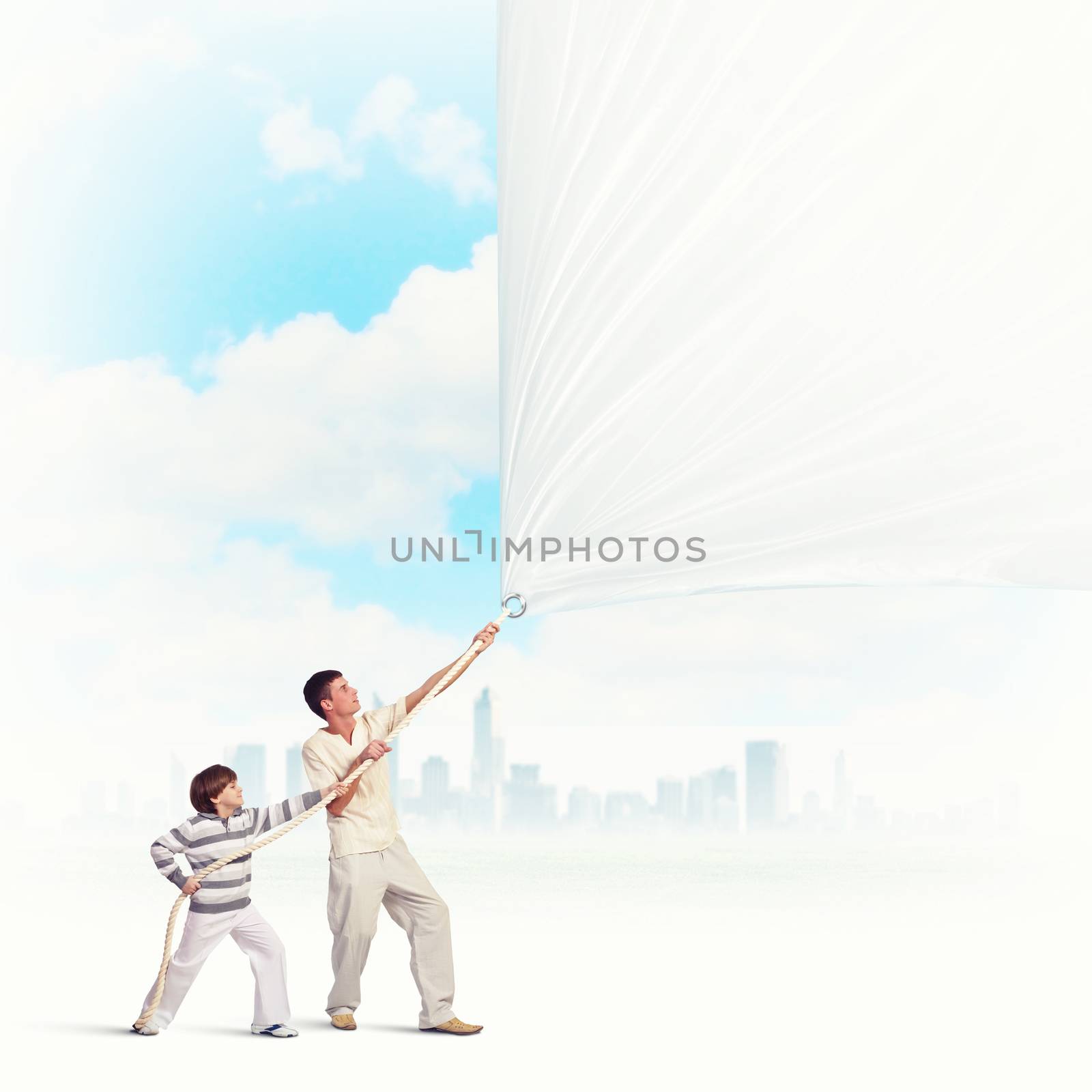 father and son pulling blank banner. Place for text