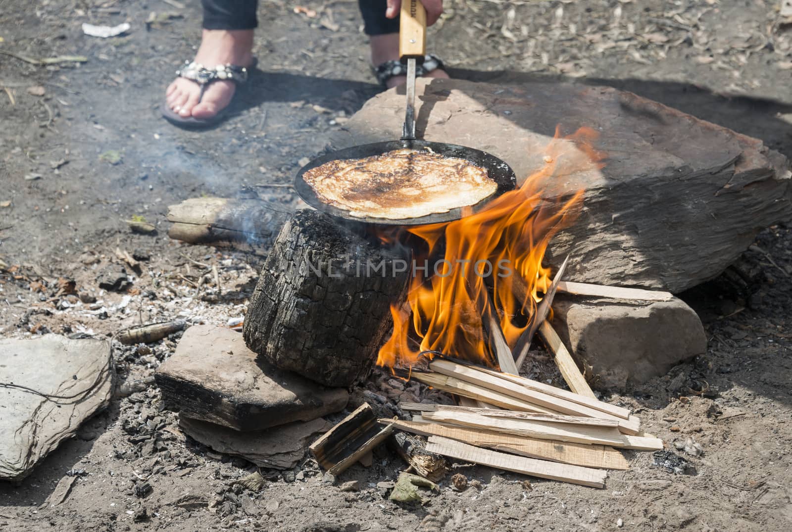 making pancake on the campfire by compuinfoto