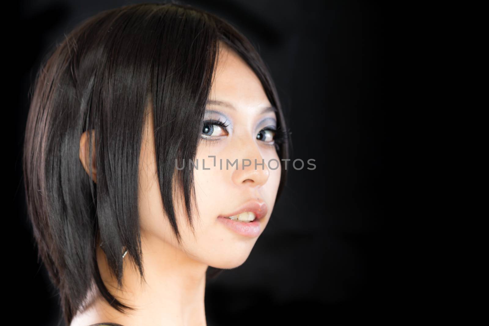 Asian female portrait on isolated black background