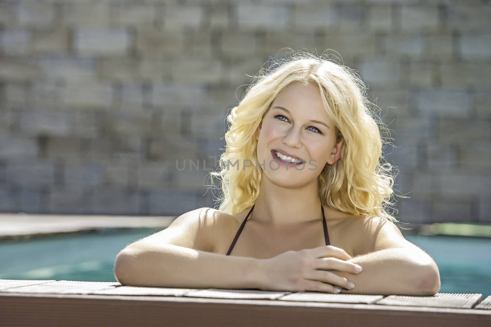 Happy blond girl in pool by w20er