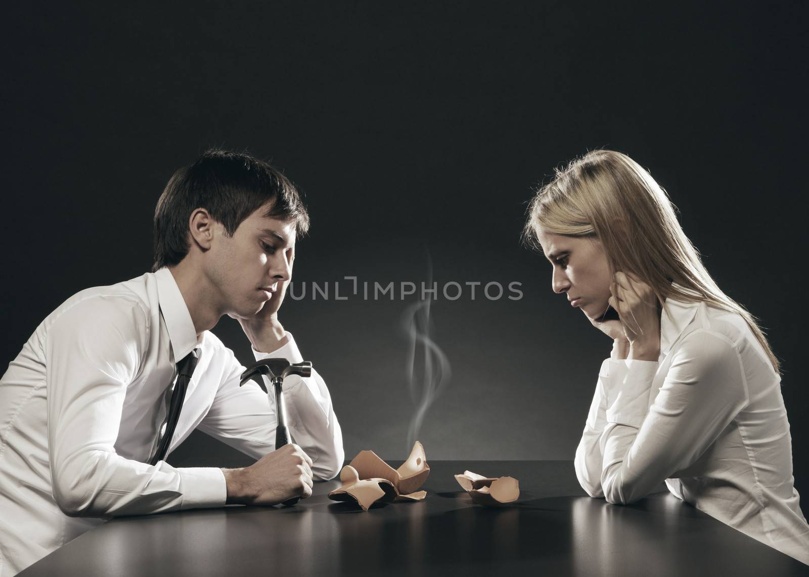 Portrait of young couple unhappy about their savings 