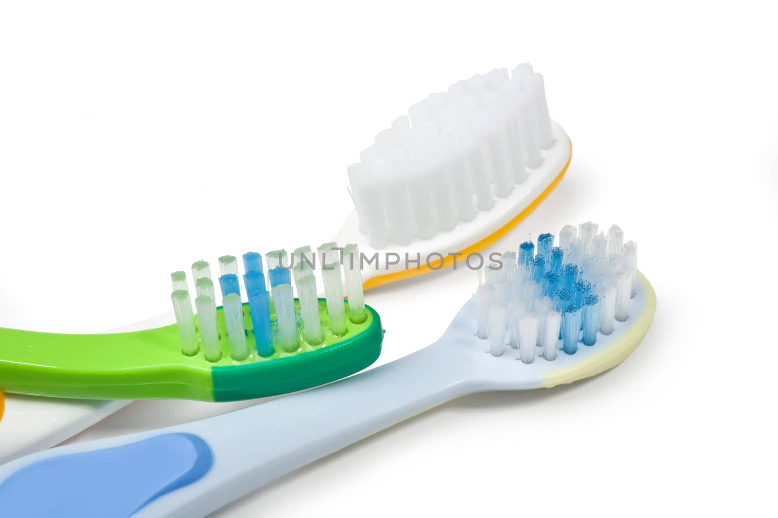 Colorful toothbrushes on white background with copy space.