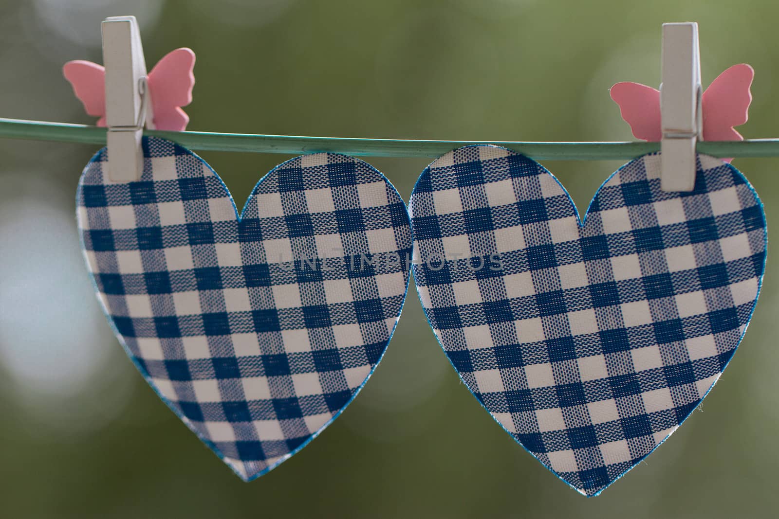 blue heart attached to a clothesline with pin