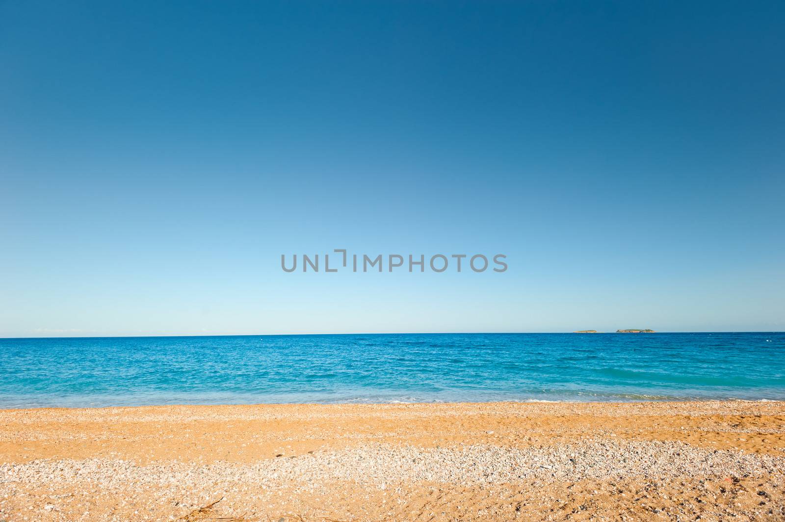 sand-and-pebble beach and a quiet, calm sea