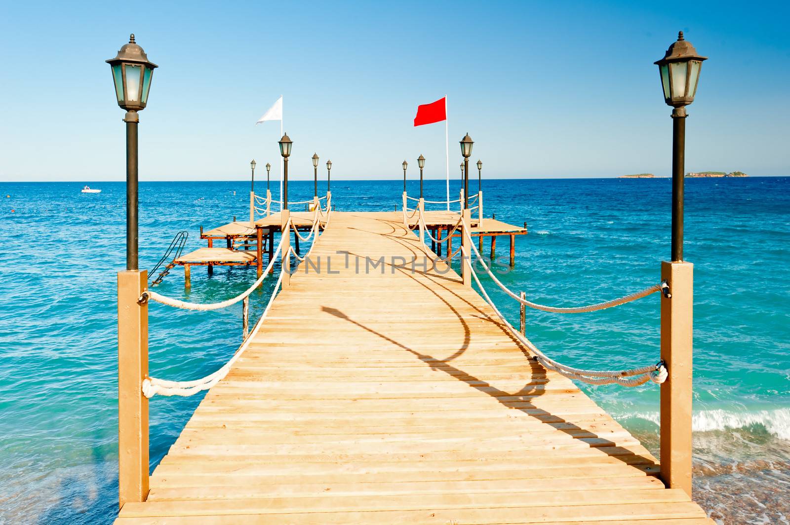 light poles and rope fence on wooden pier