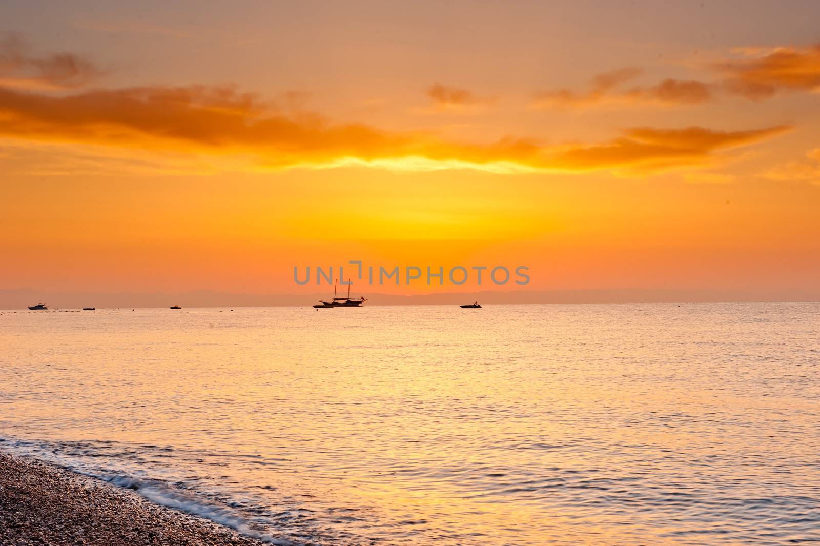 sunrise over the calm sea in orange tones