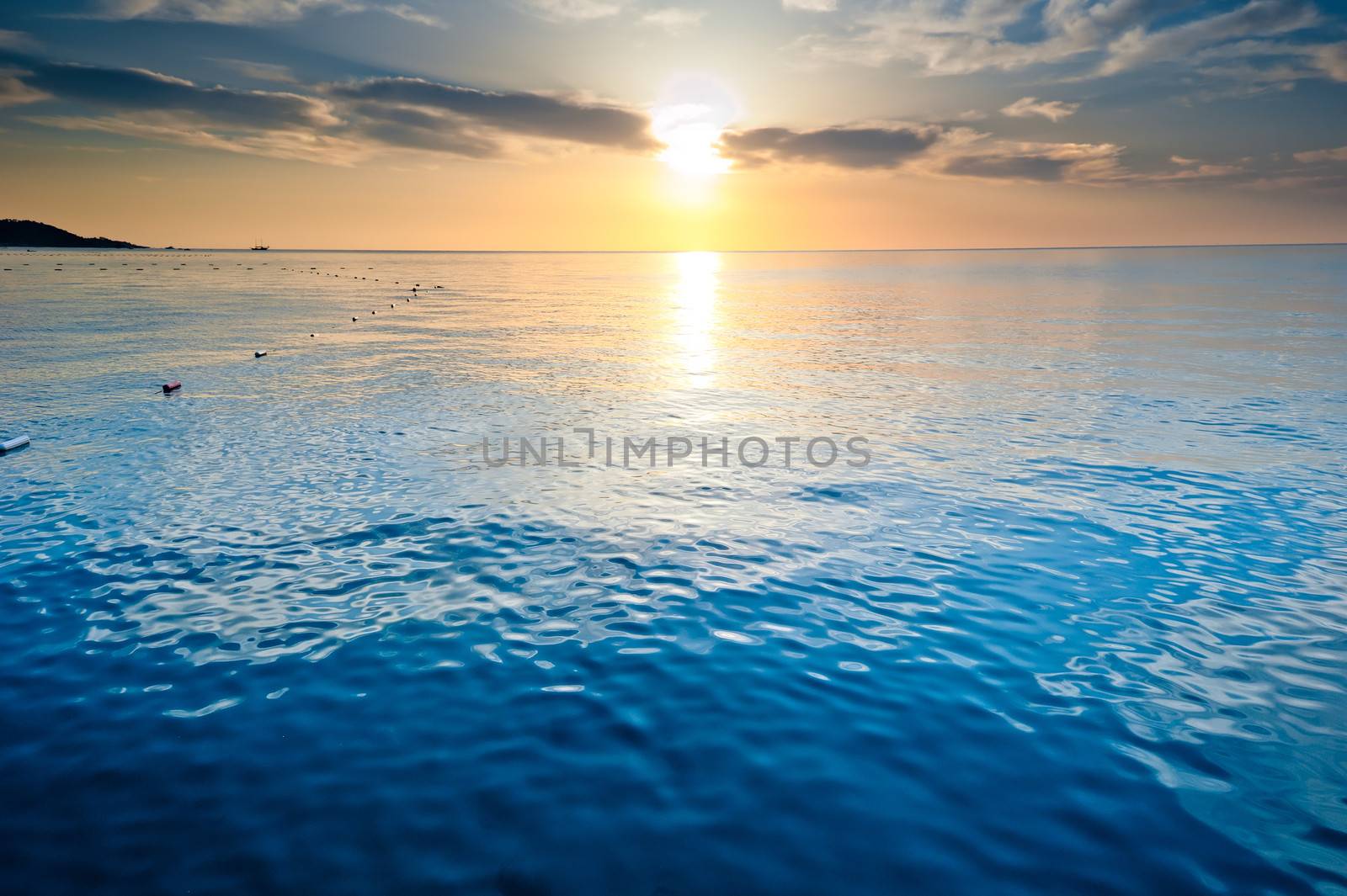 the calm sea of the rising sun lit the clouds