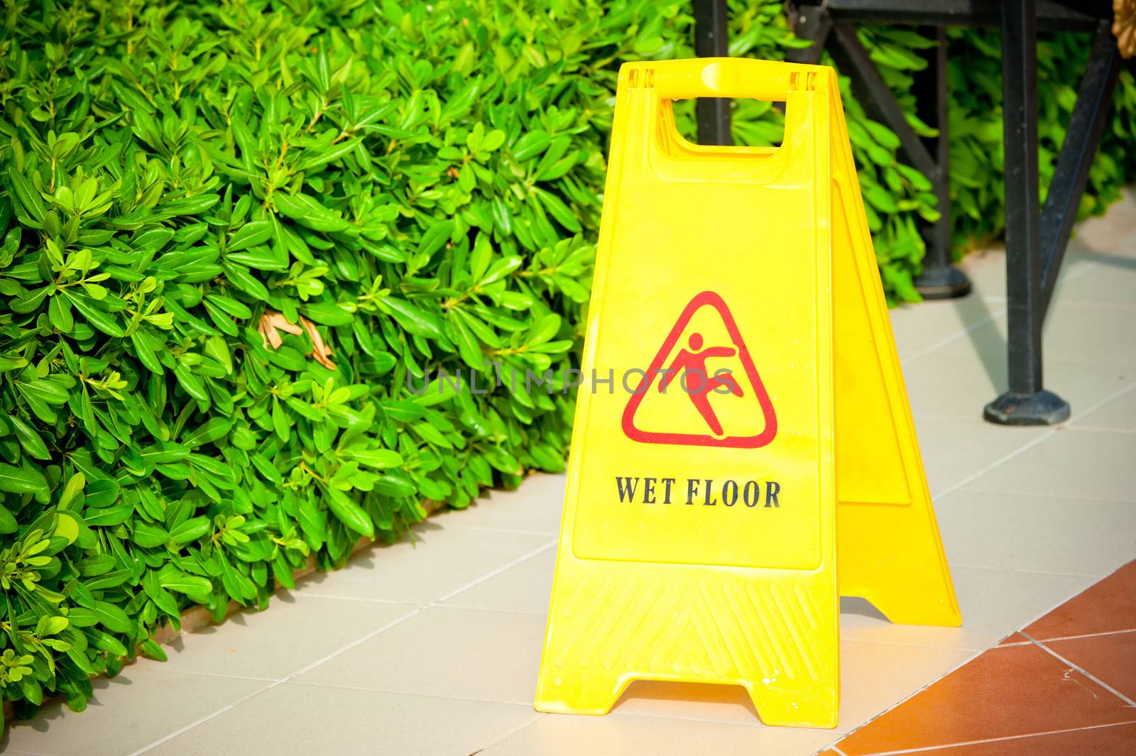 warning label "Wet floor" yellow on the tile floor